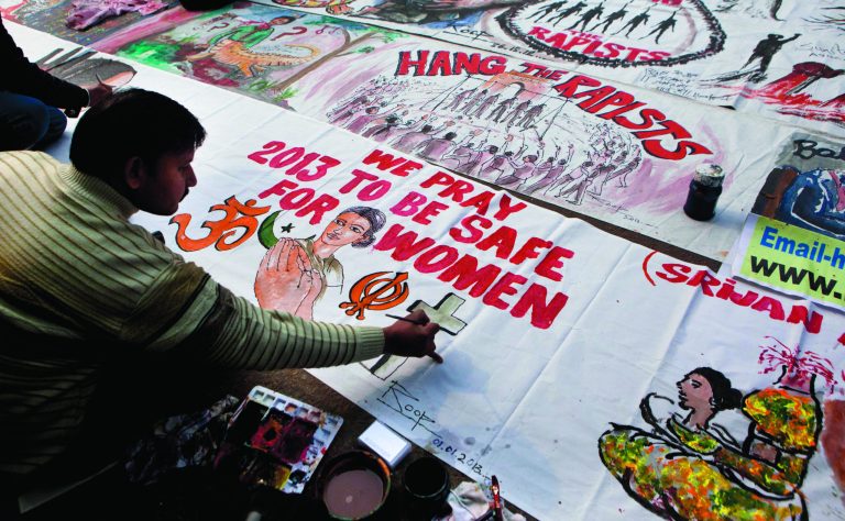 An Indian man makes a banner during a protest to mourn the death of a gang rape victim in New Delhi, India, Tuesday, Jan. 1, 2013. The gang-rape and killing of a New Delhi student has set off an impassioned debate about what India needs to do to prevent such a tragedy from happening again. The country remained in mourning Tuesday, three days after the 23-year-old physiotherapy student died from her internal wounds in a Singapore hospital. (AP Photo/Dar Yasin)
