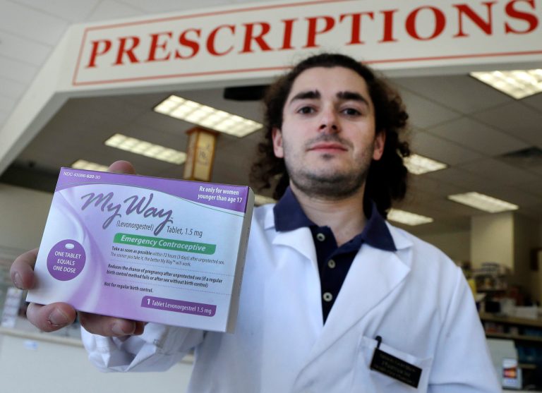 This Thursday, May 2, 2013 photo shows pharmacist Simon Gorelikov holding a generic emergency contraceptive at the Health First Pharmacy in Boston. New rules permitting 15-year-olds to get the morning-after pill without a prescription are being debated by teens as well as adults, with some saying it will help kids who can't confide in an adult, while others say the lower age infringes on a parent's right to know what's going on. (AP Photo/Elise Amendola)