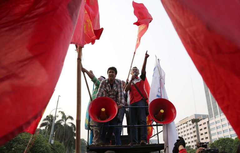 Protesters shout slogans against a regional election bill during a rally in front of the parliament building in Jakarta, Indonesia, Thursday, Sept. 25, 2014. Parliament is holding a plenary session to take decision on the new bill that aimed at returning the authority to organize the country's regional elections to the Regional Legislative Councils. (AP Photo/Achmad Ibrahim)