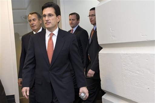 House Minority Leader Eric Cantor of Va., center, House Speaker John Boehner of Ohio, left, and others, arrive for a Republican caucus meeting on Capitol Hill in Washington, Tuesday, Jan. 1, 2013. Squarely in the spotlight, House Republicans began deciding their next move Tuesday after the Senate overwhelmingly approved compromise legislation negating a fiscal cliff of across-the-board tax increases and sweeping spending cuts to the Pentagon and other government agencies.  (AP Photo/Jacquelyn Martin)