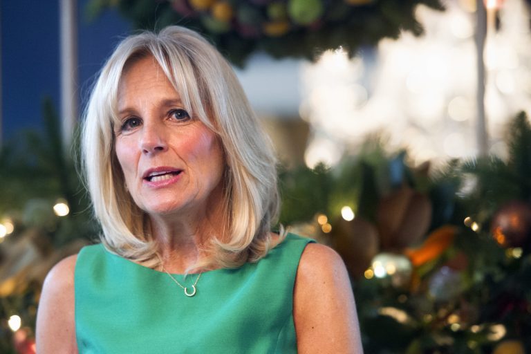 Jill Biden, wife of Vice President Joe Biden, welcomes guests to a holiday reception for service members, veterans, and their families, Wednesday, Dec. 3, 2014, at the Vice President's residence, The U.S. Naval Observatory in Washington. (AP Photo/Cliff Owen)