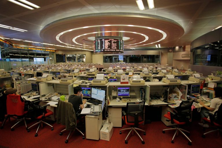 In this June 10, 2015 photo, traders work at Hong Kong's Stock Exchange in Hong Kong.Â (AP Photo)Â 