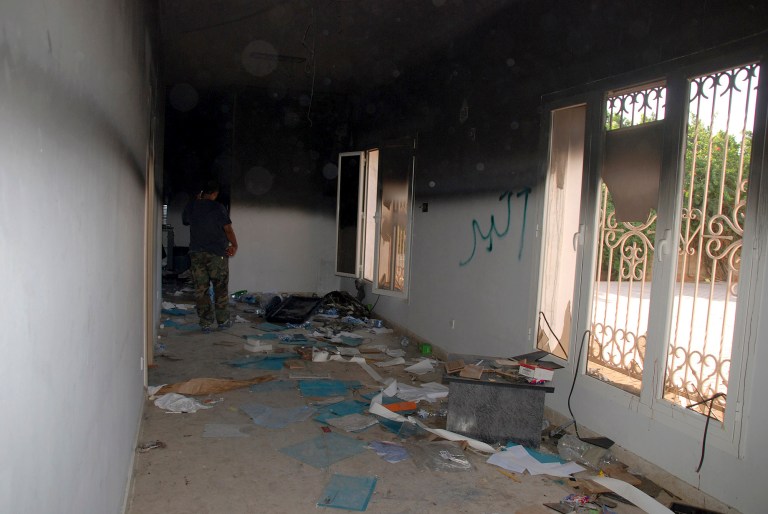 FILE - This Sept. 12, 2012 file photo shows a man walking through a room in the gutted U.S. consulate in Benghazi, Libya, after an attack that killed four Americans, including Ambassador Chris Stevens. The State Department promised Wednesday to cooperate with the House special committee looking into the deadly 2012 attack in Benghazi, Libya, expressing hope the new investigation is conducted in a fairer and more bipartisan manner than previous Republican-led probes.  (AP Photo/Ibrahim Alaguri, File)