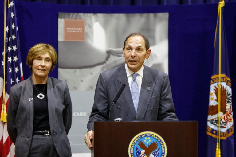 U.S. Dept. of Veterans Affairs Sec. Bob McDonalds speaks to the media as  Cincinnati VA Medical Center Dir. Linda Smith listens in Cincinnati.  McDonald toured the Cincinnati VA Medical Center and met with staffers and greeted veterans. He has been visiting centers around the country and has had hospitals hold town meetings. (AP Photo/The Cincinnati Enquirer, Carrie Cochran)  MANDATORY CREDIT;  NO SALES