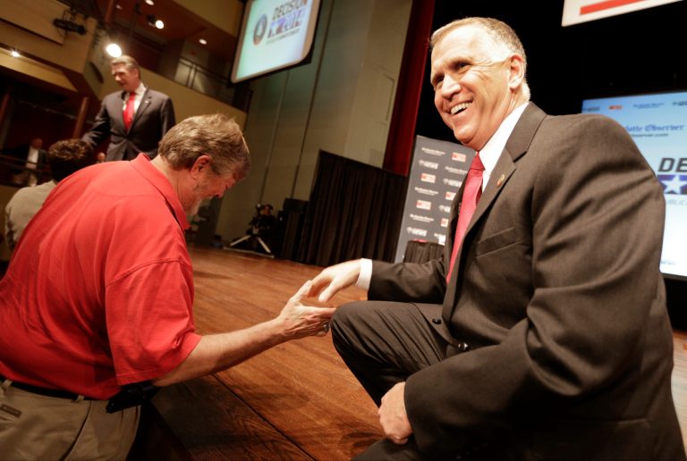 Republican senatorial candidate Thom Tillis, right, greets a supporter before a debate at Davidson College in Davidson, N.C., Tuesday, April 22, 2014. (AP Photo/Chuck Burton)