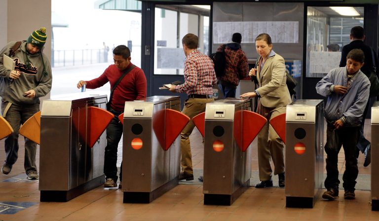 Bay Area Rapid Transit passengers enter a BART station Tuesday, Oct. 22, 2013, in Oakland, Calif. A contentious, on-again, off-again Bay Area transit strike infuriated hundreds of thousands of commuters forced to wait hours for overcrowded buses and ferries and brought grave questions when two workers were killed. The labor clash now appears to be heading toward resolution, but unions now face calls to ban transit strikes, and political leaders are struggling to assure communities they wonÃ?t be economically and socially jeopardized again by union disputes. (AP Photo/Ben Margot)