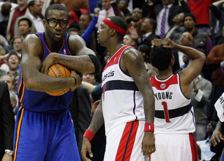 WASHINGTON, DC - JANUARY 06: Amare Stoudemire #1 of the New York Knicks (L) holds onto the ball after Nick Young #1 of the Washington Wizards missed the game tying shot at the buzzer during the Knicks win at Verizon Center on January 6, 2012 in Washington, DC. In the middle is Andray Blatche #7 of the Washington Wizards. NOTE TO USER: User expressly acknowledges and agrees that, by downloading and or using this photograph, User is consenting to the terms and conditions of the Getty Images License Agreement.  (Photo by Rob Carr/Getty Images)