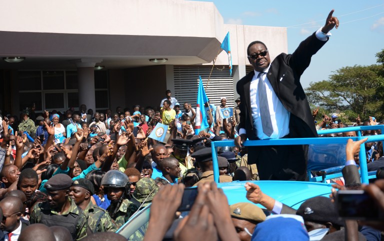 Newly elected Malawian president Peter Mutharika greets supporters after he was sworn in at the High Court in Blantyre, Malawi, Saturday May 31, 2014. Malawi's election commission has declared opposition leader  Mutharika to be the winner of an election that was marred by scattered unrest and complaints from the president and others that the vote was rigged. (AP Photo/Thoko Chikondi)