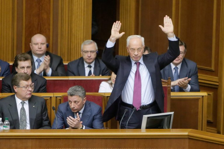 In this Dec. 3, 2013 file photo, Ukraine's Prime Minister Mykola Azarov, right, gestures to lawmakers in parliament during the session in Kiev, Ukraine. Ukrainian President Viktor Yanukovich has accepted the resignation of Azarov and his cabinet. (AP Photo/Efrem Lukatsky, FIle)