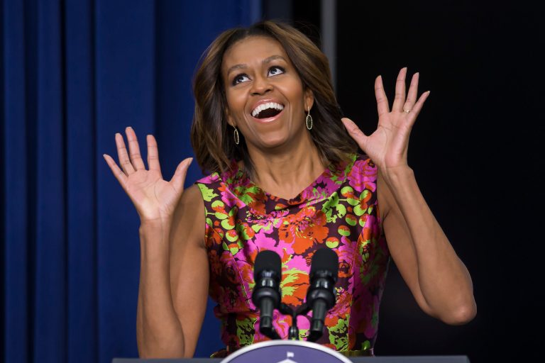 First lady Michelle Obama reacts as she introduces the cast of 