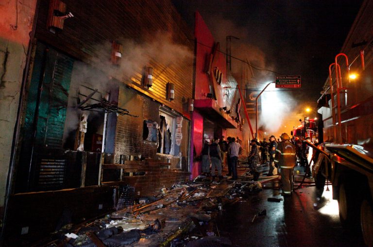FILE - In this Jan. 27, 2013 file photo, firefighters work to douse a fire at the Kiss Club in Santa Maria city, Rio Grande do Sul state, Brazil. Relatives of the victims of the nightclub fire that earlier this year killed 242 people in southern Brazil, said on Wednesday, May 22, 2013 that little has been done to improve the safety of public gathering places since the tragedy. (AP Photo/Agencia RBS)