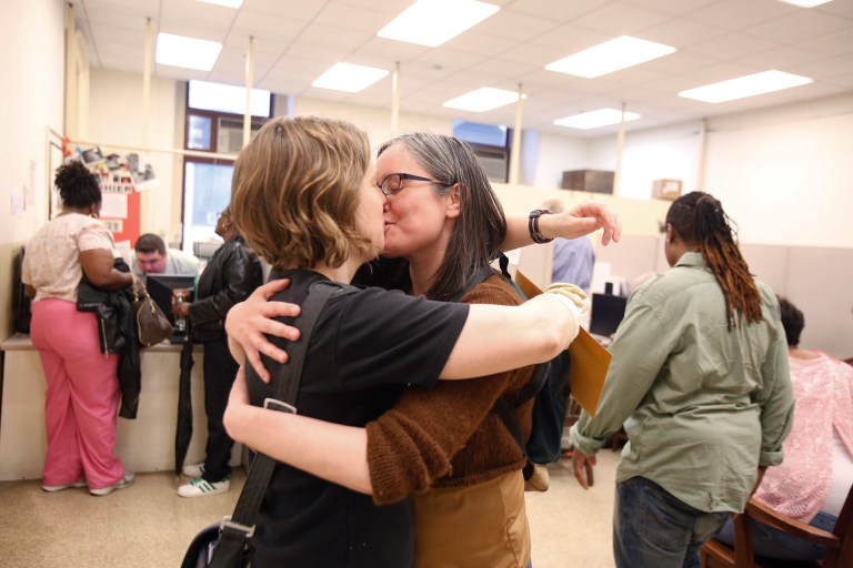 Emily Gavin and Eliza Callard kiss after getting their marriage license this morning at the Register of Wills at City Hall in Philadelphia on Wednesday, May 21, 2014. (AP/The Philadelphia Inquirer, Ed Hille)