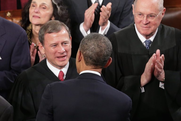 Supreme Court Chief Justice John Roberts, left, and Associate Justice Anthony Kennedy, right, talk with President Barack Obama before he delivers the State of the Union address to a joint session of Congress in the House Chamber at the U.S. Capitol on January 28, 2014 in Washington, D.C. (Photo by Chip Somodevilla/Getty Images)