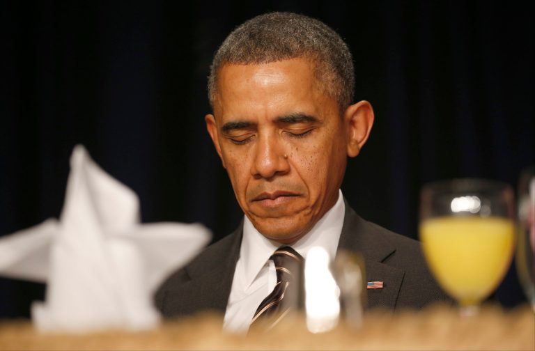 President Obama bows his head as a prayer is offered at the National Prayer Breakfast in Washington on Feb. 6. (AP Photo/Charles Dharapak)
