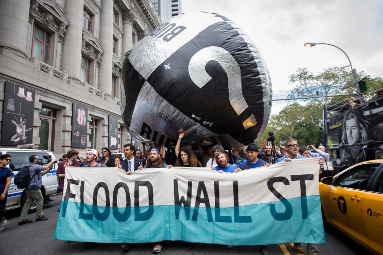 Demonstrators march towards Wall Street from Battery Park to protest for action on climate change and corporate greed on Sept. 22, a day after a huge climate march in New York City. (AP/John Minchillo)
