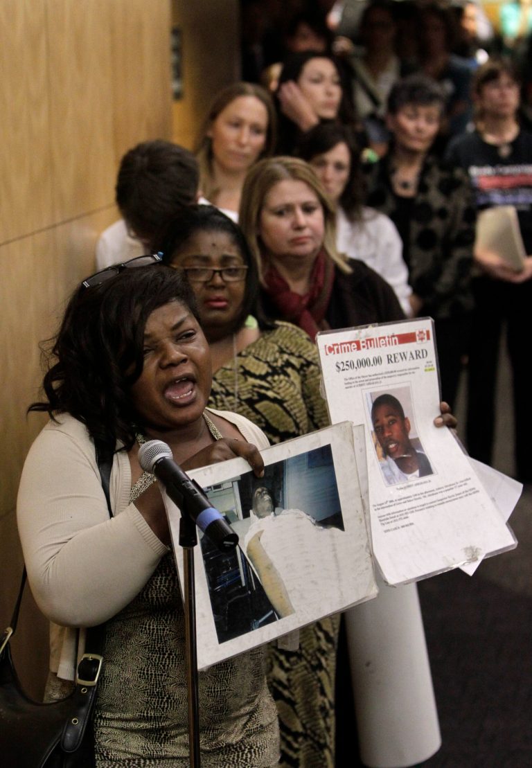 Paulette Brown displays photos of her son, Aubrey Abrakasa, Jr. 17, who was shot and killed in San Francisco in 2006, while urging lawmakers to approve a bill by Senate President Pro Tem Darrell Steinberg, D-Sacramento, to outlaw rifles with detachable magazines, while appearing before the Senate Public Safety Committee in Sacramento, Calif., Tuesday, April 16, 2013. Brown was one of dozen's of people who called for the passage Steinberg's measure, SB374, one of seven bills that Senate Democrats have proposed to tighten California's already strict gun control laws.(AP Photo/Rich Pedroncelli)