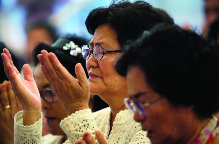 Followers pray for the Rev. Sun Myung Moon during a service at a Unification Church in Seoul, South Korea, Tuesday, Sept. 4, 2012. Moon, the self-proclaimed messiah who founded the church, died Monday at a church-owned hospital near his home in Gapyeong County, northeast of Seoul, church officials said. He was 92. (AP Photo/Hye Soo Nah)