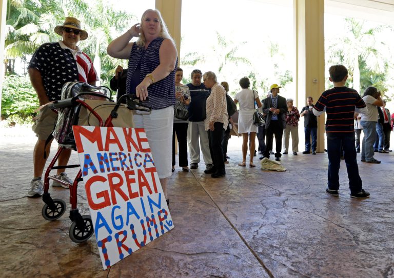 A Trump supporter stands with a sign as she waits to enter the site ofÂ a campaign stop, Friday, Oct. 23, 2015.Â According to the poll, only 23 percent of likely Republican voters say he is 