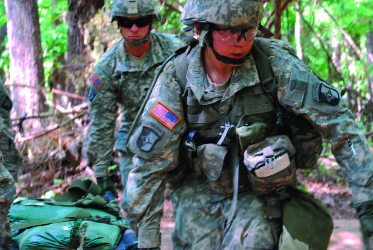FILE - In a May 9, 2012 file photo, Capt. Sara Rodriguez, 26, of the 101st Airborne Division, carries a litter of sandbags during the Expert Field Medical Badge training at Fort Campbell, Ky. The Pentagon is lifting its ban on women serving in combat, opening hundreds of thousands of front-line positions and potentially elite commando jobs after generations of limits on their service, defense officials said Wednesday, Jan. 23, 2013. (AP Photo/Kristin M. Hall, File)