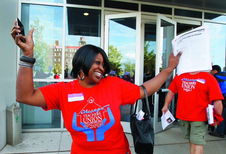 FILE - In this Sept. 18, 2012 file photo, Tennille Evans, a member of the Chicago Teachers Union's House of Delegates, celebrates after the delegates voted to suspend the teachers' seven-day strike against the school district in Chicago. The hard part now comes for Chicago Mayor Rahm Emanuel who must figure out how to pay for it all, and won't rule out school closings and a property tax increase, both of which would be hugely unpopular. (AP Photo/Charles Rex Arbogast, File)