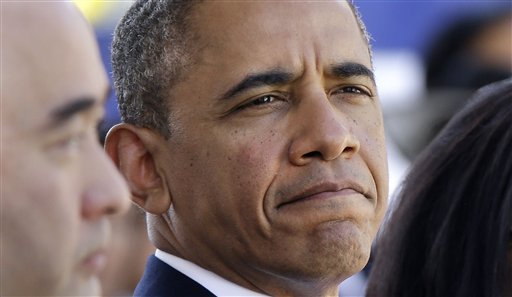 President Barack Obama attends the Memorial Service for Sen. Daniel Inouye, D-Hawaii, at the Punchbowl National Memorial Cemetery of the Pacific in Honolulu, Sunday, Dec. 23, 2012. Left is Inouye's son, Daniel Inouye, Jr. (AP Photo/Gerald Herbert)