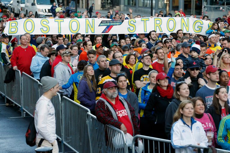 A crowd gathers at the finish line of the Boston Marathon in Boston for a Sports Illustrated photo shoot before the one-year anniversary of the Boston Marathon bombings, Saturday, April 12, 2014. (AP Photo/Michael Dwyer)
