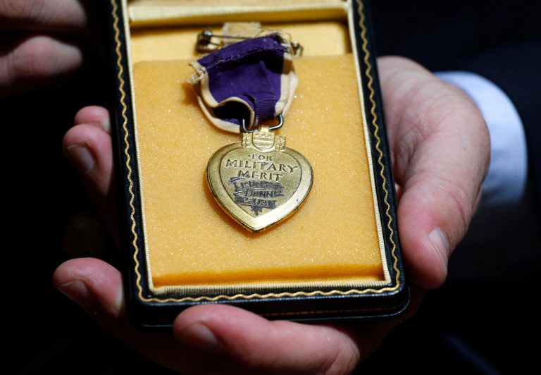 Purple Hearts Reunited founder Capt. Zachariah Fike displays a Purple Heart from Pearl Harbor in Denver, Thursday Aug. 7, 2014.