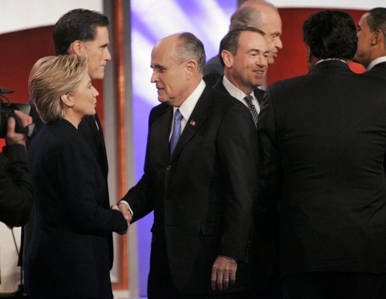 Republican presidential hopeful, former New York City Mayor Rudy Giuliani, greets Democratic presidential hopeful, Sen. Hillary Clinton, D-N.Y., as Republican presidential hopeful former, Massachusetts Gov. Mitt Romney and Republican presidential hopeful, former Arkansas Gov. Mike Huckabee, right, mix on the stage during a break between the televised Republican and Democratic presidential debates in Manchester, N.H. (AP Photo/Steven Senne)