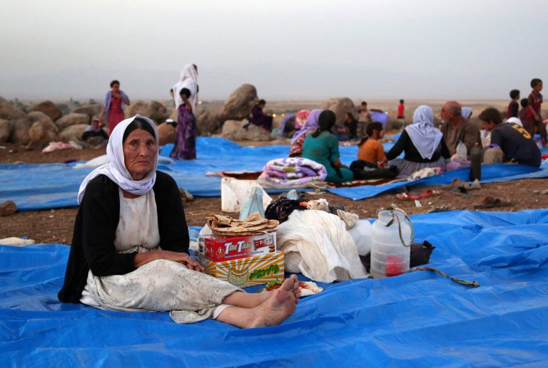 In this Sunday, Aug. 10, 2014 file photo, displaced Iraqis from the Yazidi community settle at a camp at Derike, Syria.