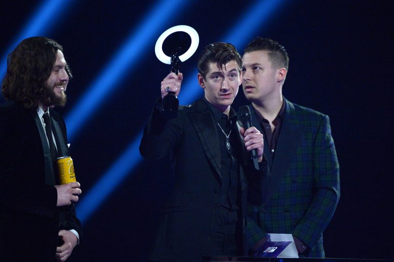 Arctic Monkeys band member Alex Turner accepts the Best British Group award onstage at the BRIT Awards 2014 at the O2 Arena in London on Wednesday, Feb. 19, 2014. (Photo by Jon Furniss/Invision/AP)