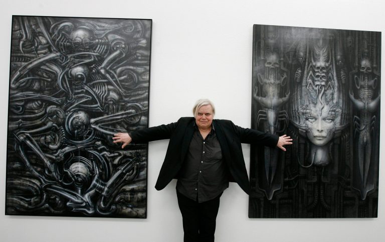 FILE - In this June 29, 2007 file picture  Swiss artist H.R. Giger  poses with two of his works at the art museum in Chur, Switzerland.  H.R. Giger, who designed the creature in Ridley Scott's sci-fi horror classic 