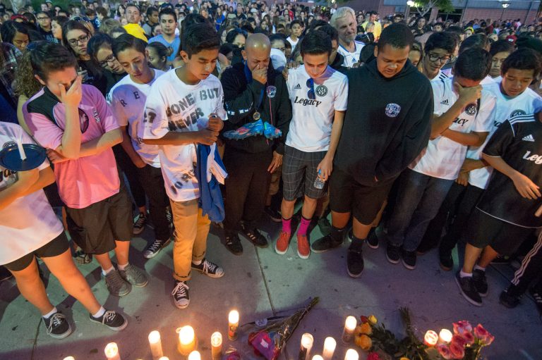 Attendees mourn during a candlelight vigil at Capistrano Valley High School on Sunday, Oct. 5, 2014, in Mission Viejo, Calif. Five students died in a single-vehicle car crash early Saturday. (AP Photo/The Orange County Register, Kyusung Gong) MAGS OUT; LOS ANGELES TIMES OUT