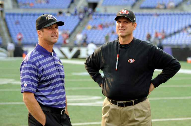 Baltimore Ravens head coach John Harbaugh, left, and San Francisco 49ers head coach Jim Harbaugh chat before an NFL preseason football game in Baltimore. (AP Photo/Nick Wass)
