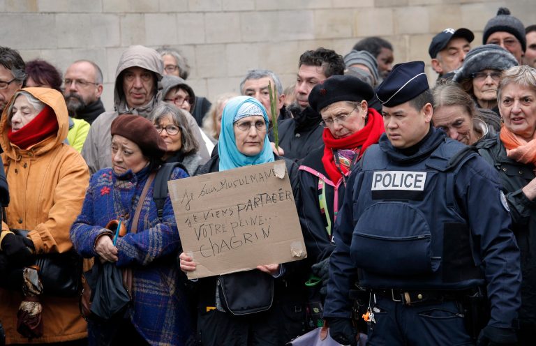 A woman holds a board reading: 