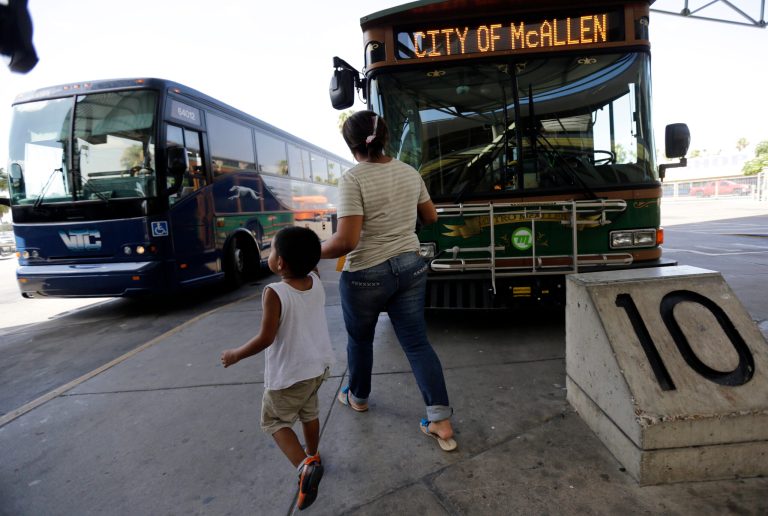In this June 20, 2014 photo, Cindy Jimenez, 26, from Olancho, Honduras, and her son depart the bus station in McAllen, Texas. Jimenez crossed illegally into the U.S. (AP Photo/Eric Gay)