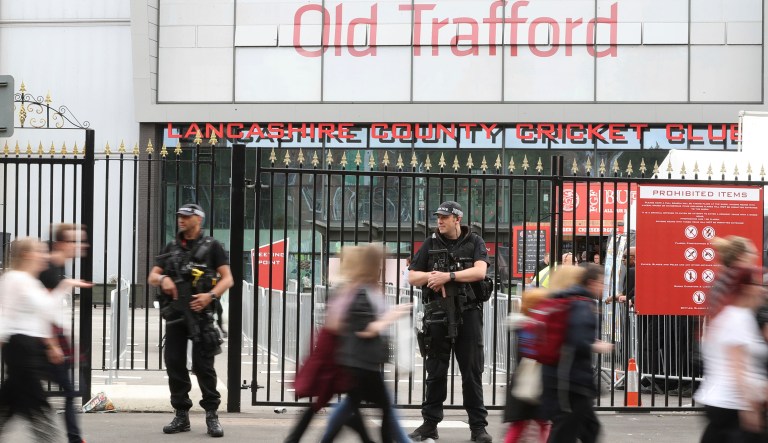 An armed police presence as crowds arrive to attend the One Love Manchester benefit concert Sunday June 4, 2017, for the victims of last month's Manchester Arena terror attack at the Emirates Old Trafford, Manchester, England. (Owen Humphreys/PA via AP)