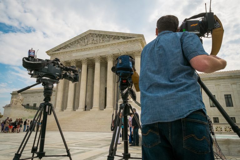 FILE - This April 22, 2104 file photo shows videojournalists setting up outside the Supreme Court in Washington. The court said Monday it will hear the case of a Florida fisherman who wants the court to throw out his conviction for getting rid of some small grouper under a federal law originally aimed at the accounting industry. Commercial fishing boat captain John Yates argues that the federal government used its mighty power to convict him of tossing overboard three fish that were under the 20-inch minimum legal size for red grouper caught in the Gulf of Mexico.  (AP Photo/J. David Ake, File)