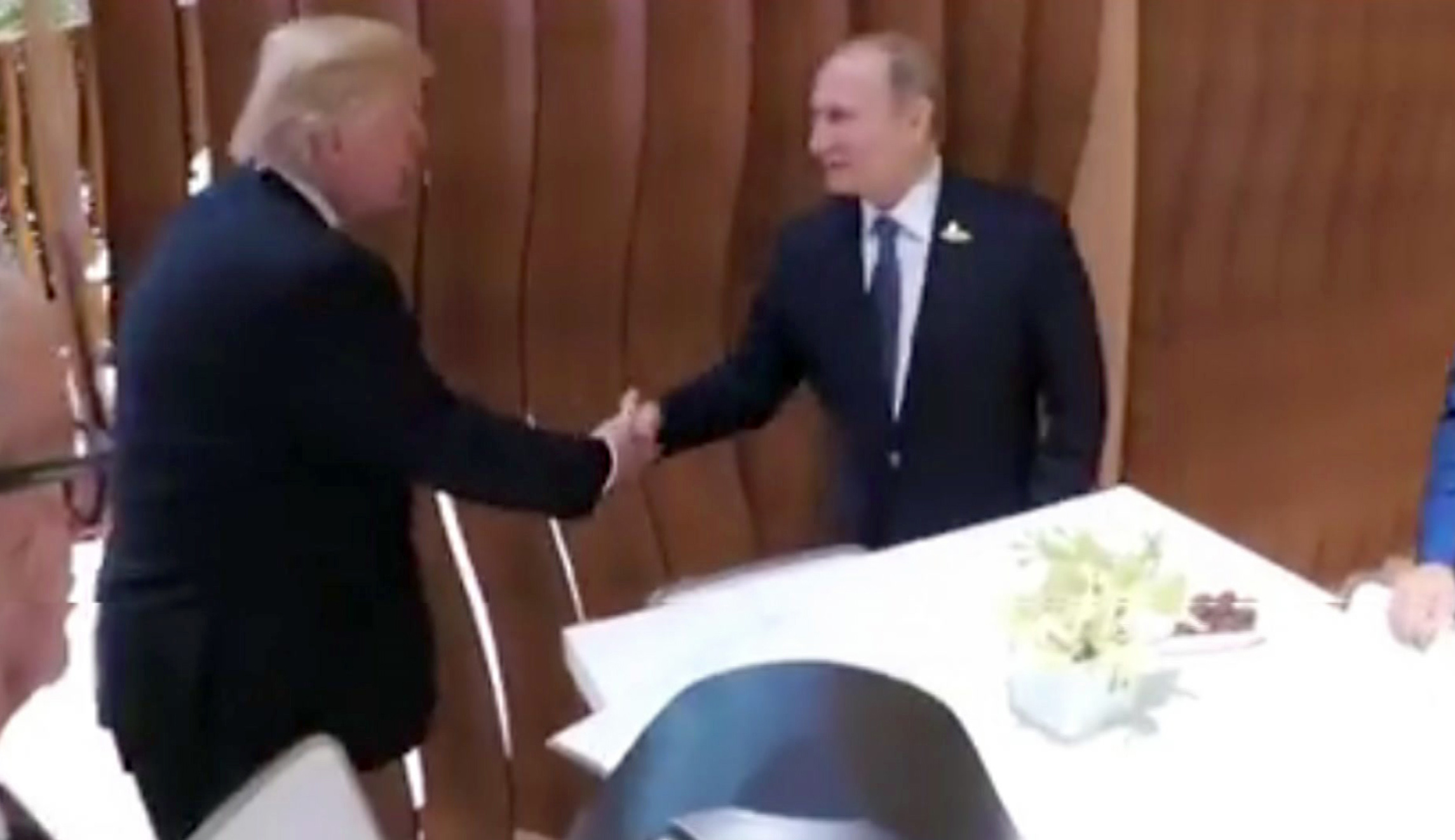 Trump and Putin shake hands: WATCH