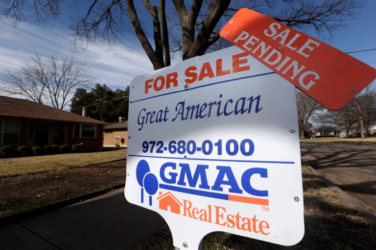 FILE - In this Friday, Feb. 22, 2013, file photo, a sale pending announcement sits atop a for sale sign in a home's yard in Richardson, Texas.  The number of Americans who signed contracts to buy homes dropped sharply in September 2013 to the lowest level in nine months, reflecting higher mortgage rates and home prices that have made purchases more costly.  (AP Photo/LM Otero, File)