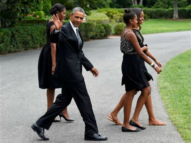 The Obama attended the New York wedding of their chef Sam Kass, at an added to cost to taxpayers of nearly $300,000. AP Photo