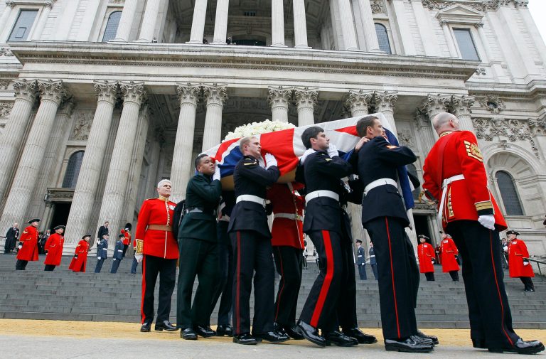 Former British Prime Minister Margaret Thatcher's coffin is carried by pallbearers out from St Paul's Cathedral, following the ceremonial funeral service in London, Wednesday, April 17, 2013. Thatcher, who died, at the age of 87 on 8 April, has been accorded a ceremonial funeral with military honours, one step down from a state funeral, Thatcher was elected Prime Minister on May 4, 1979 and she resigned on Nov. 28, 1990, after eleven years in office. (AP Photo/Alastair Grant)