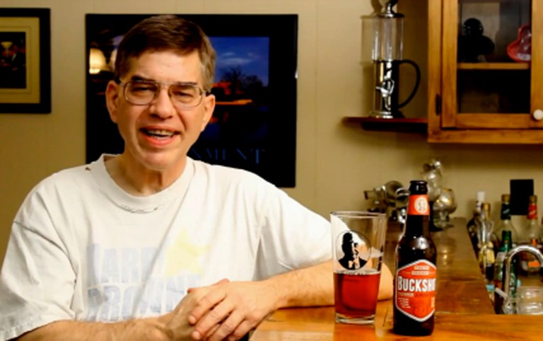 Libertarian candidate Sean Haugh sits at a bar, pint glass in hand, and talks about issues affecting voters. (Screenshot)