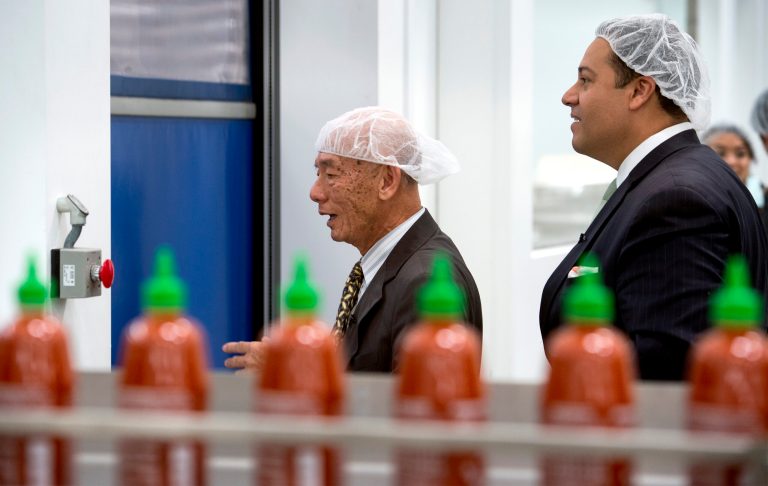 Texas State Representative Jason Villalba, right, of Dallas, Texas, tours the Huy Fong Foods, Inc. manufacturing plant, maker of Sriracha hot sauce, with founder and CEO David Tran, in Irwindale, Calif. May 12, 2014.  Texas officials are trying to convince the Sriracha maker to move to their state after the city of Irwindale declared them a public nuisance. (AP Photo/San Gabriel Valley Tribune,  Leo Jarzomb)