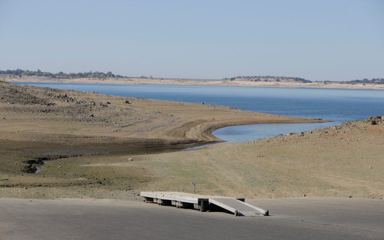 In this photo taken Oct. 6, 2014, a dock sits high and dry at the end of a boat ramp yards away from the edge of Folsom Lake near Folsom, Calif. The California Department of Water Resources reported Tuesday, Oct. 7, 2014, the largest monthly decline in water use this year as the severity of California's drought hits home.  Water suppliers reported that consumption fell 11.5 percent in August compared with the year before. (AP Photo/Rich Pedroncelli)