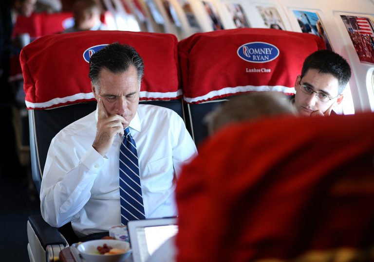 Former Massachusetts Gov. Mitt Romney (left) sits with adviser Oren Cass (right) aboard his campaign plane on November 2, 2012 en route to Milwaukee, Wisconsin. (Photo by Justin Sullivan/Getty Images)