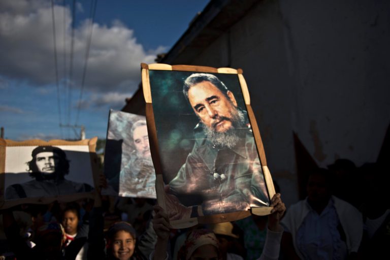 Children carry framed images of Fidel Castro in a caravan tribute in Regla, Cuba. (AP/Ramon Espinosa)