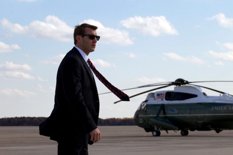 A Secret Service agent scans the area as President Barack Obama boards Air Force One, before departure from Andrews Air Force Base, Md., Thursday, Oct. 30, 2014. (AP Photo/Jose Luis Magana)