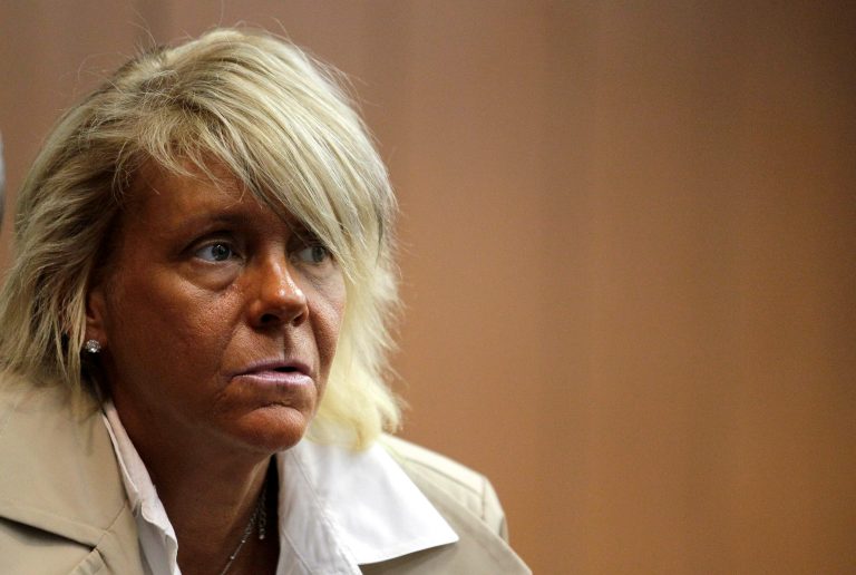   FILE - In this May 2, 2012 file photo, Patricia Krentcil, 44, waits to be arraigned at the Essex County Superior Court in Newark, N.J., where she appeared on charges of endangering her 6-year-old child by taking her into a tanning salon. The northern New Jersey tanning salon frequented by Krentcil has been fined $5,200 for numerous alleged violations, including overexposure. State Department of Health spokeswoman Donna Leusner said the inspection was based on news coverage of the deeply tanned Krentcil. But Leusner wouldn't say whether the patron who was allegedly allowed too many tanning sessions was Krentcil. (AP Photo/Julio Cortez, File)  