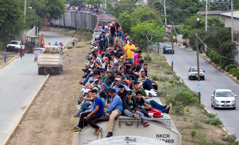 FILE - In this April 29, 2013, file photo, Migrants ride on top of a northern bound train toward the US-Mexico border in Juchitan, southern Mexico. Prosecutors in southern Mexico have filed a criminal complaint, Tuesday April, 2014, that alleges railway companies or their employees were complicit in crimes against migrants who ride their trains. The attorney general of the Gulf coast state of Veracruz says he filed a complaint with federal prosecutors against the Ferrosur Mexican rail line and a subsidiary of the U.S. line Kansas City Southern. (AP Photo/Eduardo Verdugo,File)