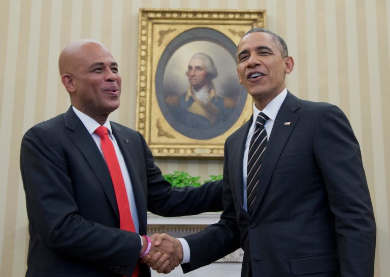 President Barack Obama and Haiti President Michel Martelly shake hands during a photo opportunity in the Oval Office of the White House in Washington, Thursday, Feb. 6, 2014. (AP Photo/Carolyn Kaster)